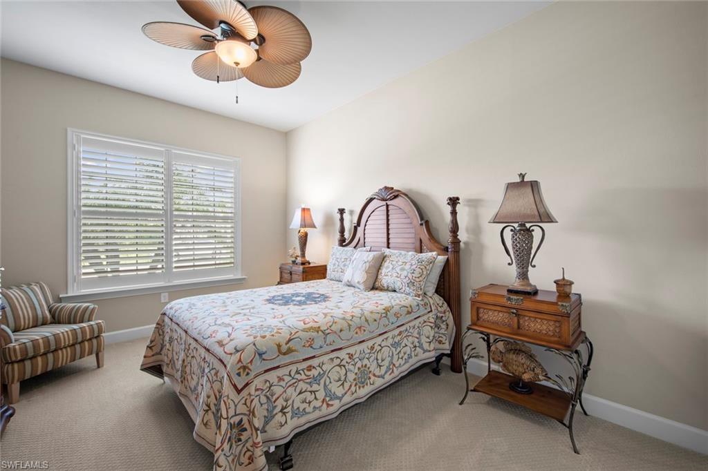 20762 Corkscrew Shores Boulevard Estero, FL 33928 - Photo 19 of 32 a bedroom with a bed chair and window
