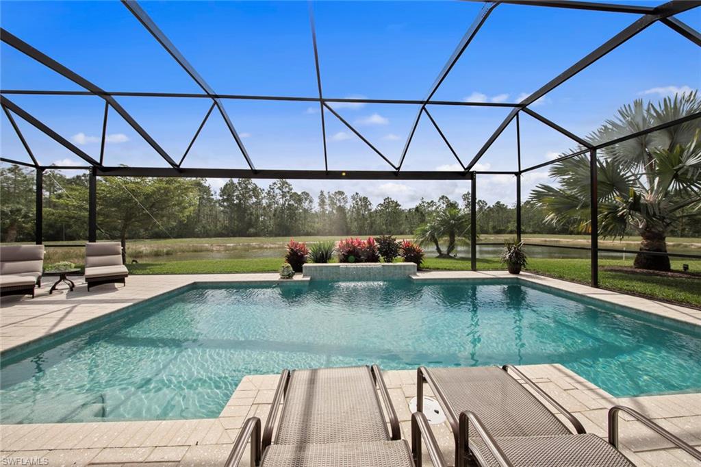 20762 Corkscrew Shores Boulevard Estero, FL 33928 - Photo 2 of 32 a view of a swimming pool with a patio
