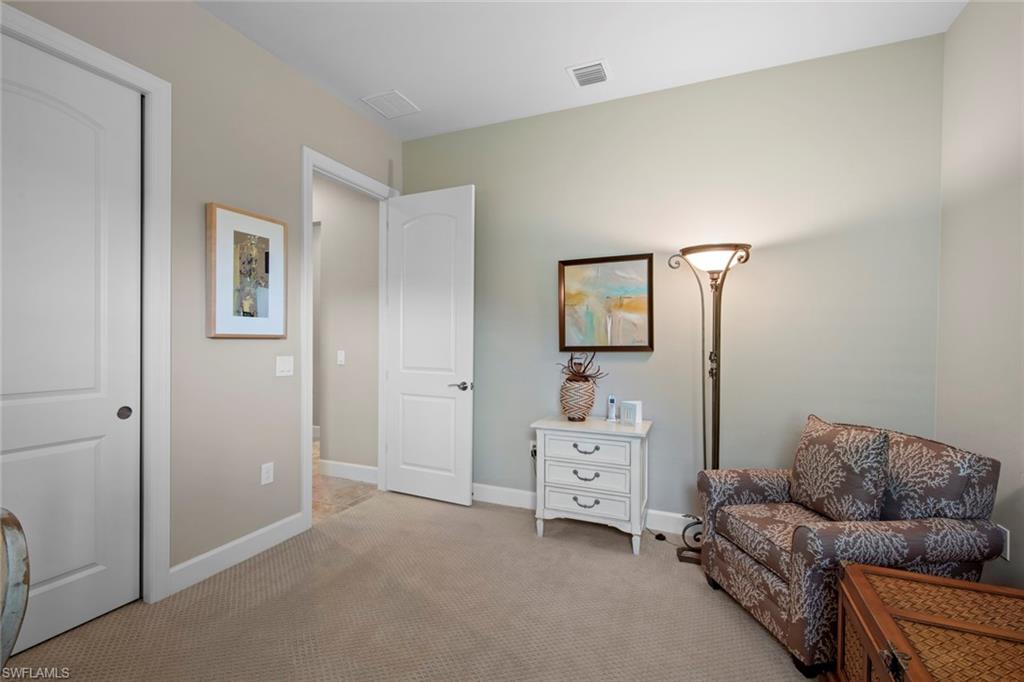 20762 Corkscrew Shores Boulevard Estero, FL 33928 - Photo 21 of 32 a bedroom with furniture and a couch