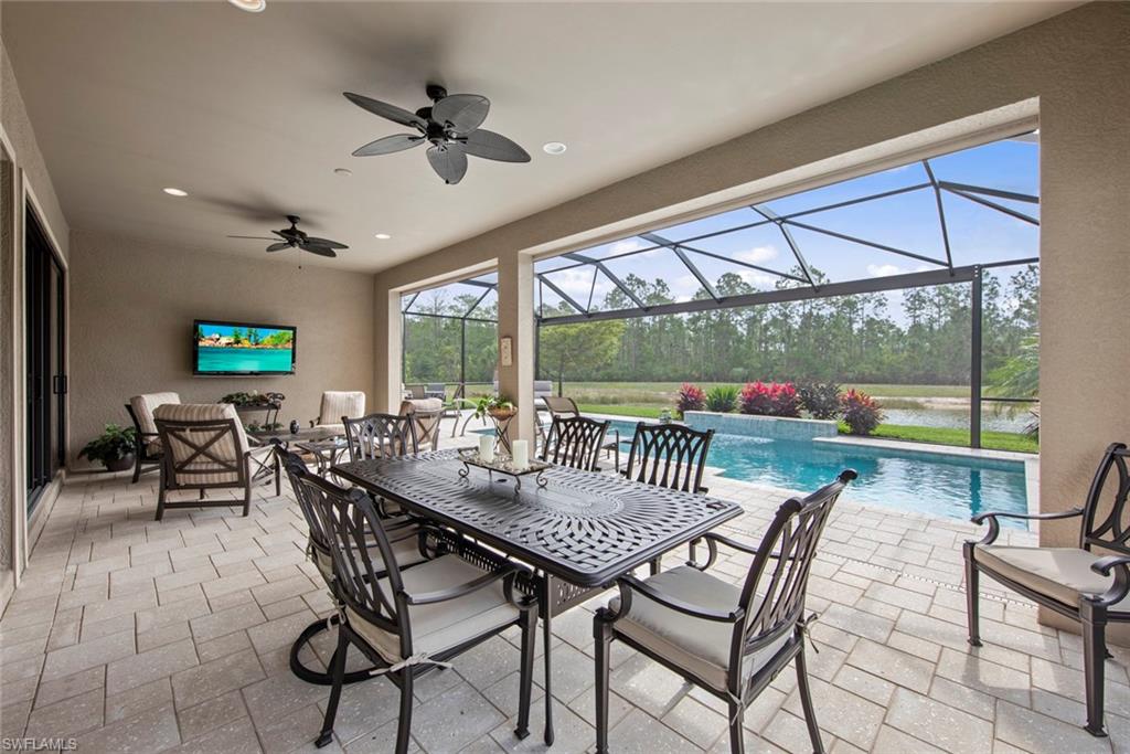 20762 Corkscrew Shores Boulevard Estero, FL 33928 - Photo 23 of 32 a dining room with furniture a chandelier and wooden floor
