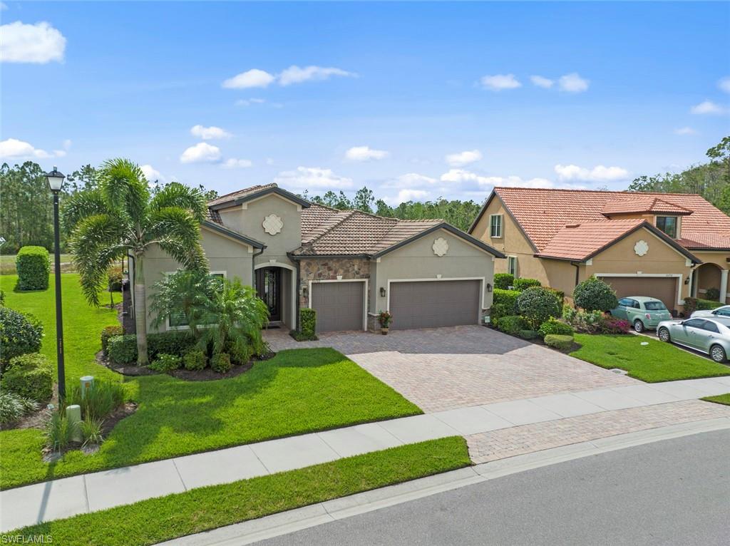 20762 Corkscrew Shores Boulevard Estero, FL 33928 - Photo 32 of 32 a front view of a house with a yard and garage