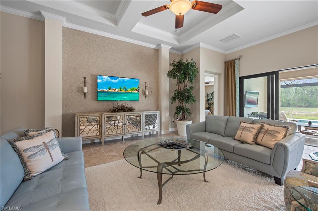 20762 Corkscrew Shores Boulevard Estero, FL 33928 - Photo 7 of 32 a living room with furniture a large window and a flat screen tv