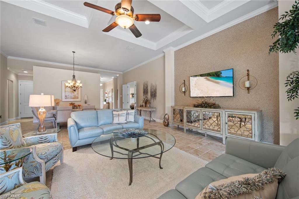 20762 Corkscrew Shores Boulevard Estero, FL 33928 - Photo 8 of 32 a living room with furniture a rug and a chandelier