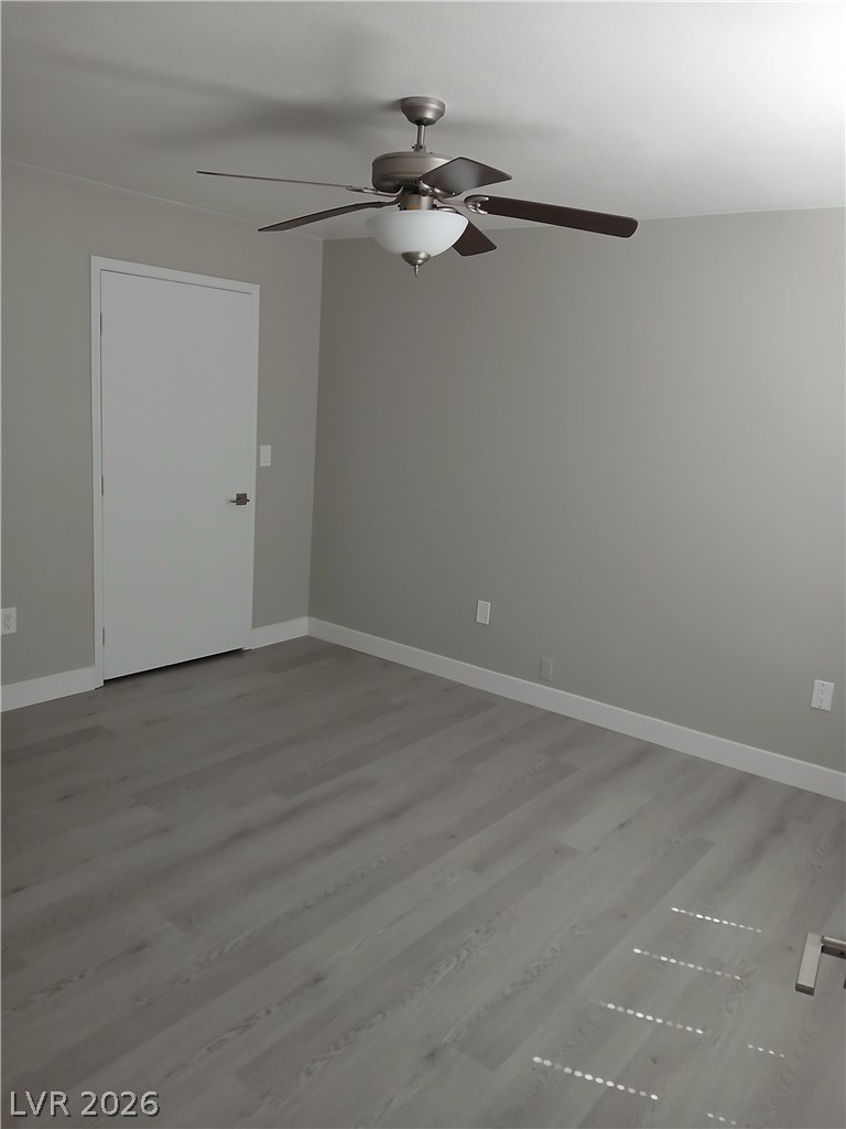 555 East Silverado Ranch Boulevard, Unit 1098 Las Vegas, NV 89183 - Photo 2 of 10 A quiet space featuring resilient plank flooring and a modern ceiling fan for comfort.