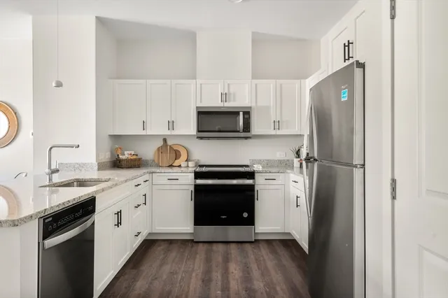 a kitchen with a refrigerator stove and sink