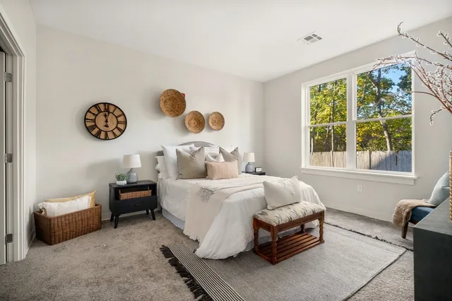 a bedroom with bed and a window