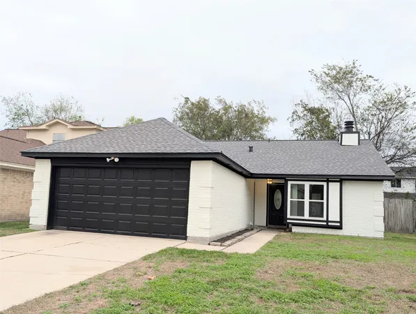 a front view of a house with a garden and yard