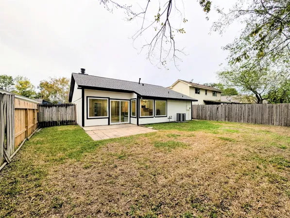 a view of a house with a yard and sitting area