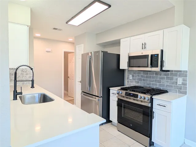 a kitchen with a sink and cabinets