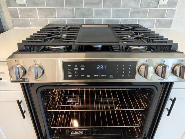 a kitchen with a sink appliances and cabinets
