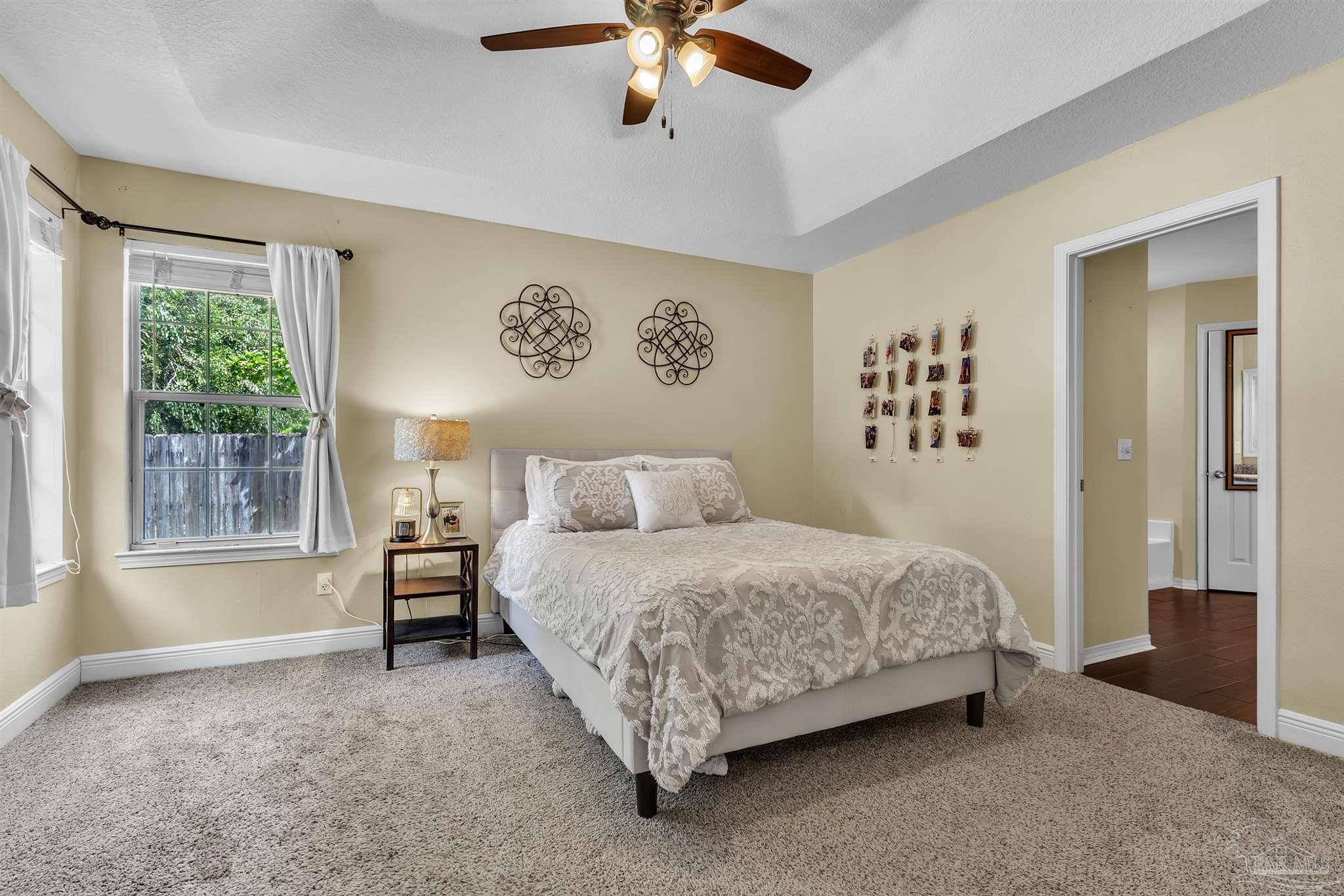 4321 Ridgeland Drive Pace, FL 32571 - Photo 13 of 36 a spacious bedroom with a bed and a large window