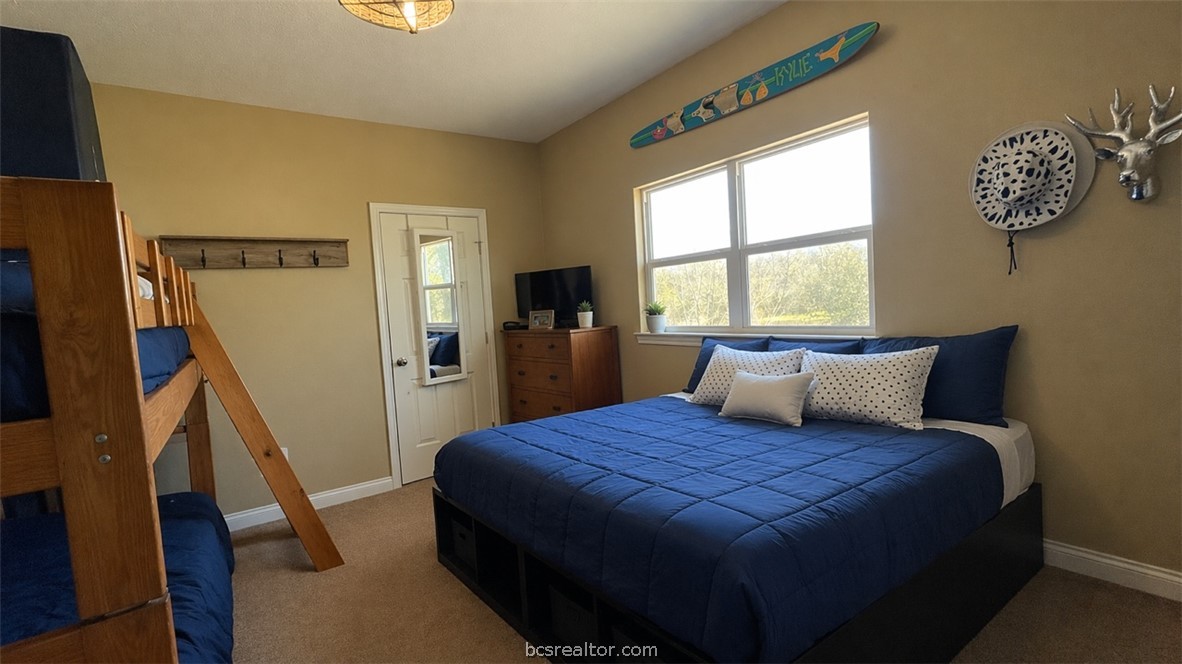 11810 Riley Green Road Franklin, TX 77856 - Photo 18 of 36 a bed sitting in a bedroom next to a window