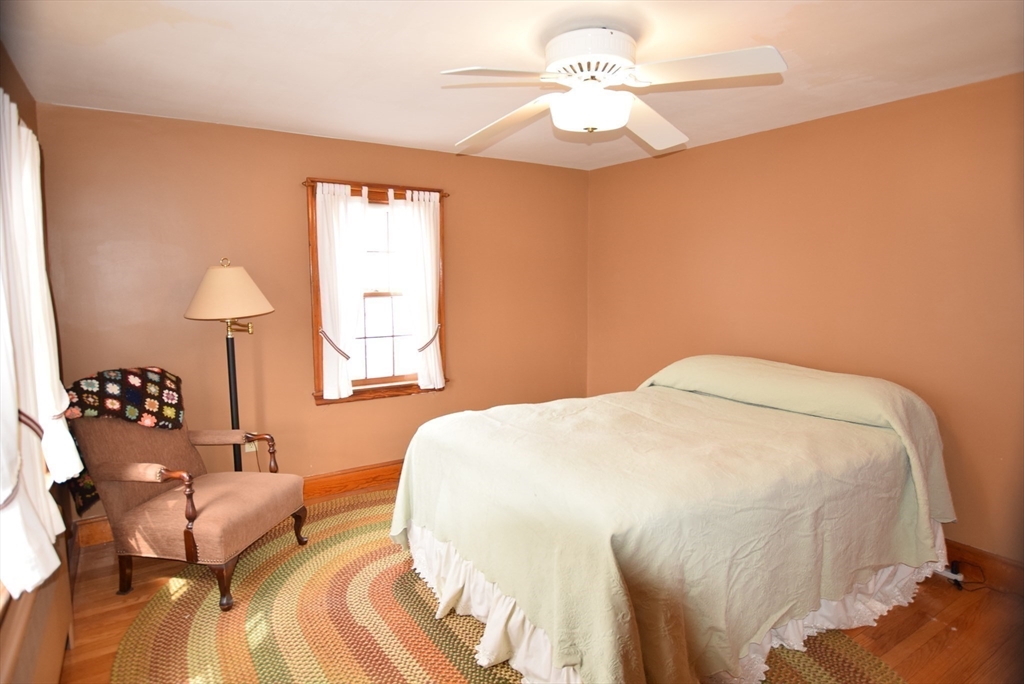 42 Herbert Street Wakefield, MA 01880 - Photo 9 of 16 a bedroom with a bed and a chandelier