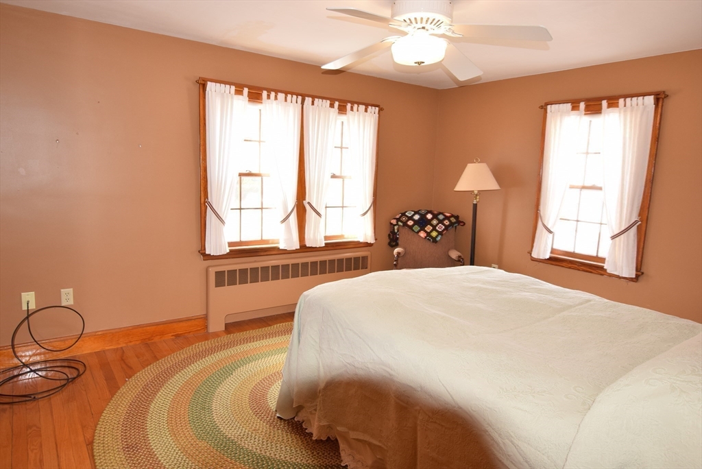 42 Herbert Street Wakefield, MA 01880 - Photo 10 of 16 a bedroom with a bed and a chandelier