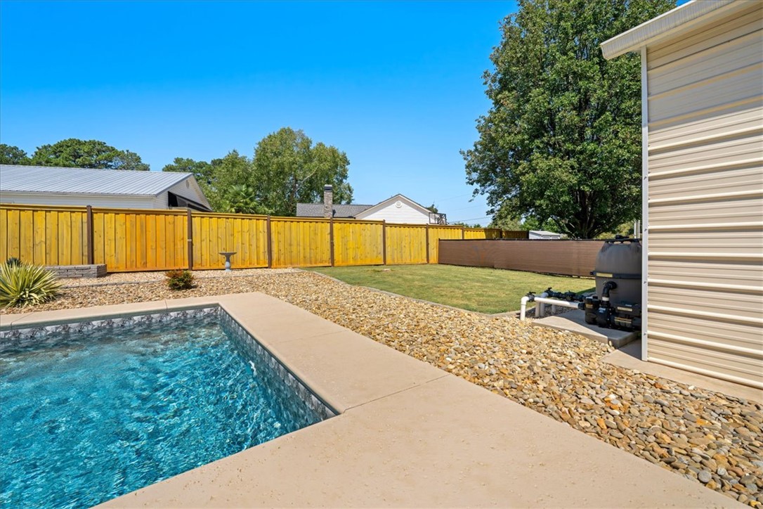 623 New Hope Road Anderson, SC 29626 - Photo 39 of 49 A pristine concrete deck surrounds the sparkling pool, bordered by a secure privacy fence.