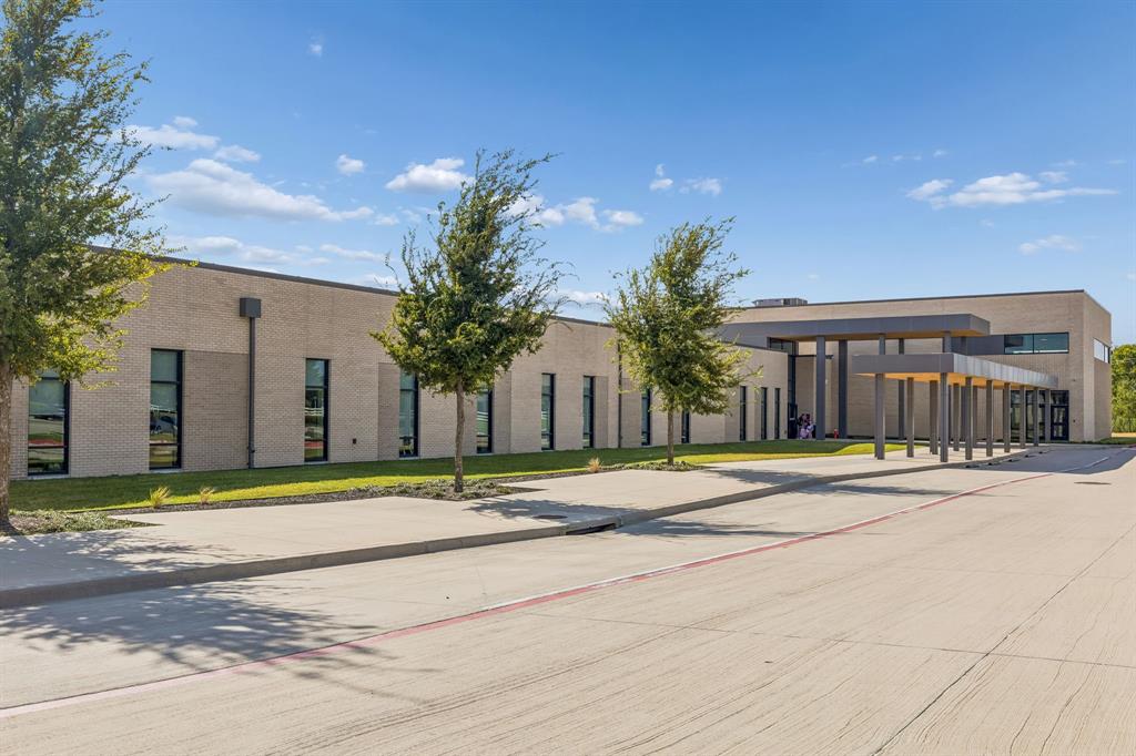5224 Troupe Road McKinney, TX 75071 - Photo 31 of 31 Modern brick exterior with expansive windows, an extended porte-cochere, and mature landscaping