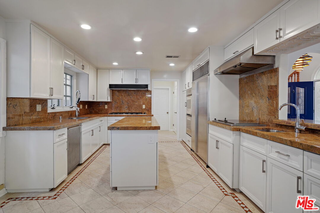 131 Reef Mall Marina del Rey, CA 90292 - Photo 12 of 43 a kitchen with granite countertop a sink and white cabinets
