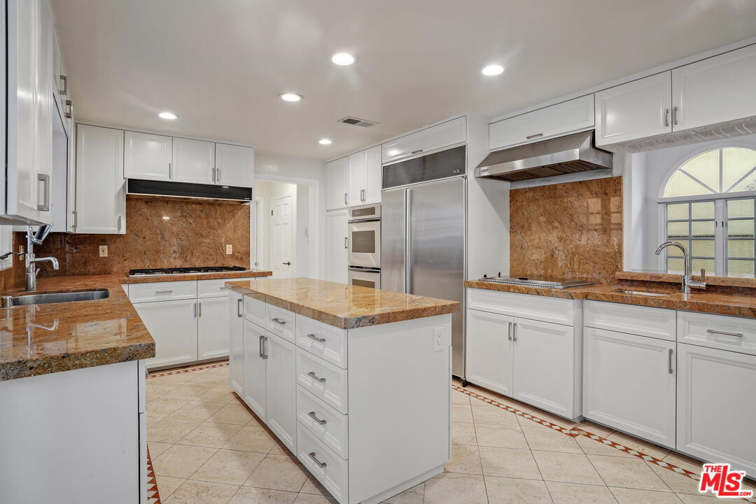 131 Reef Mall Marina del Rey, CA 90292 - Photo 13 of 43 a kitchen with granite countertop white cabinets and white appliances