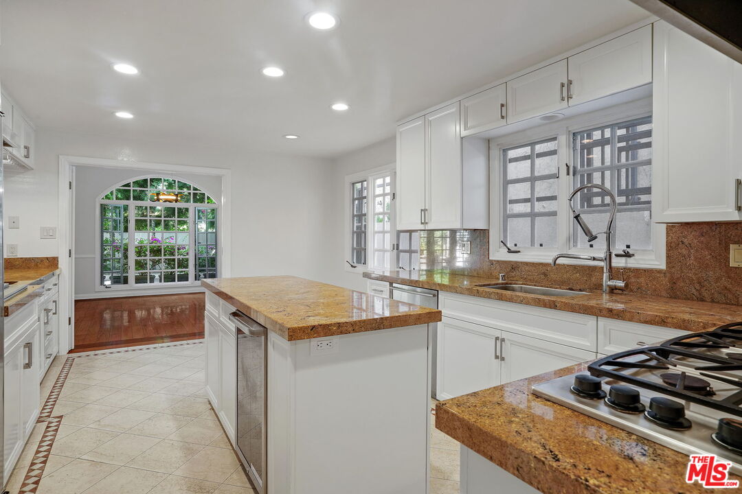 131 Reef Mall Marina del Rey, CA 90292 - Photo 14 of 43 a kitchen with a stove a sink and a refrigerator