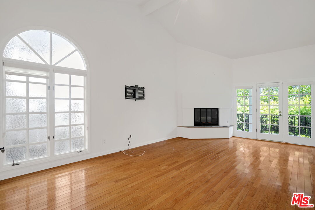 131 Reef Mall Marina del Rey, CA 90292 - Photo 19 of 43 a view of an empty room with a window and wooden floor
