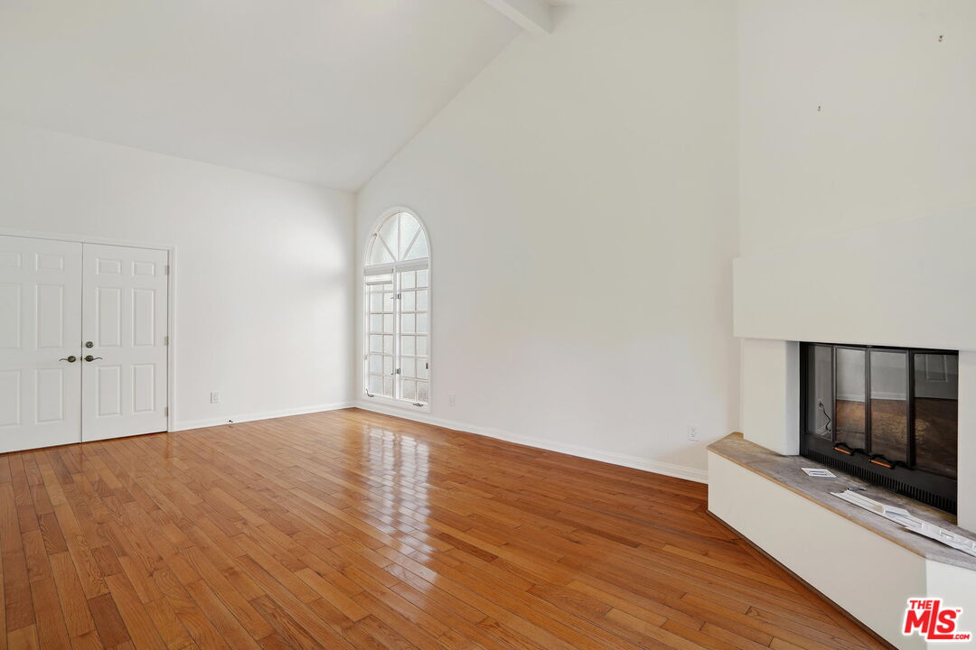 131 Reef Mall Marina del Rey, CA 90292 - Photo 22 of 43 a view of empty room with wooden floor and fireplace