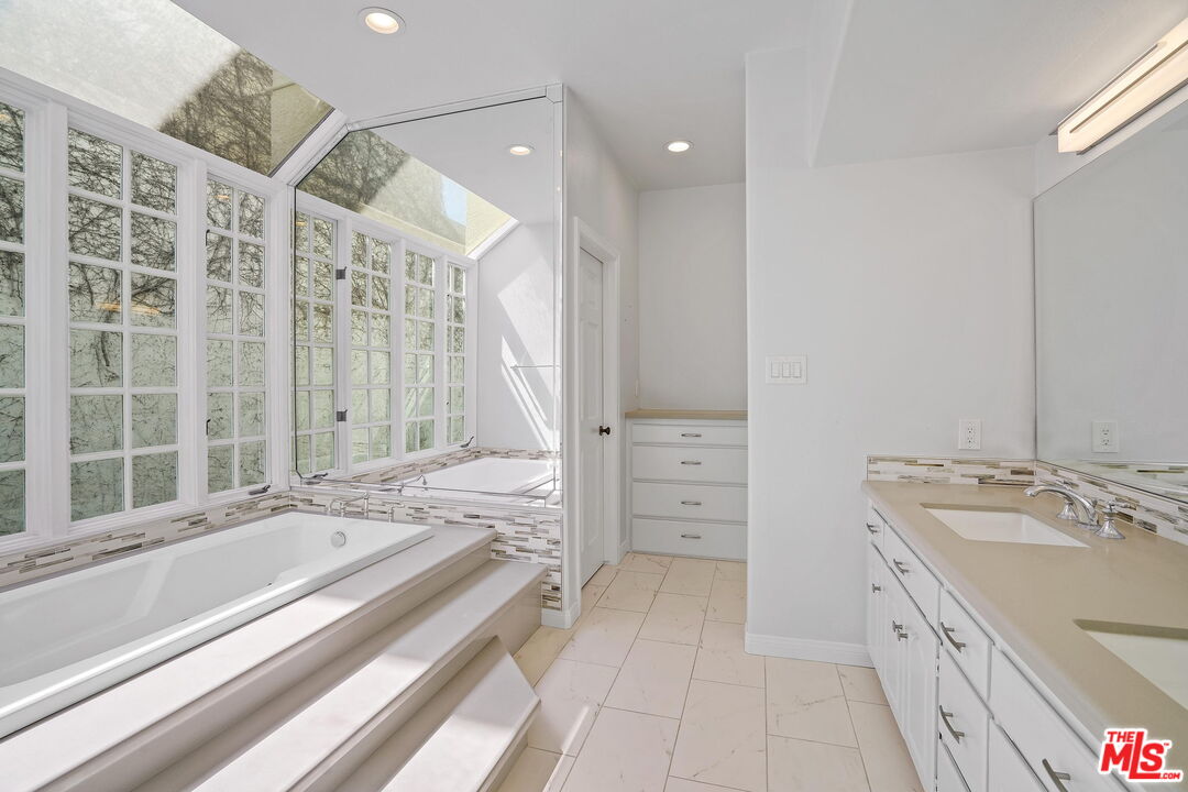 131 Reef Mall Marina del Rey, CA 90292 - Photo 24 of 43 a spacious bathroom with a double vanity sink a mirror and a shower