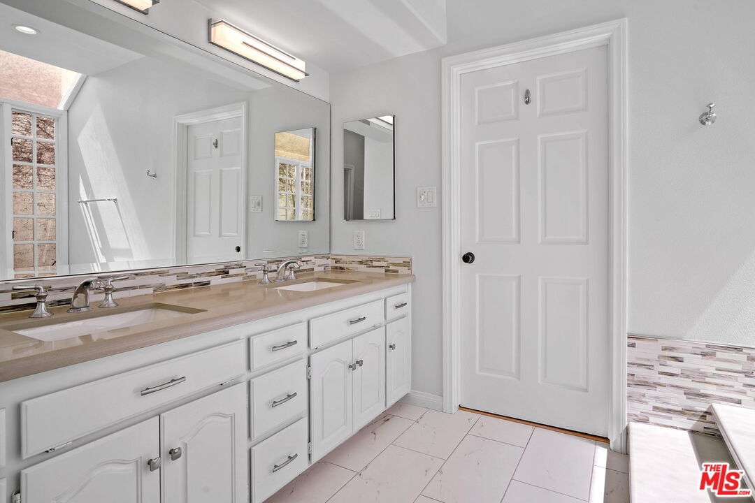 131 Reef Mall Marina del Rey, CA 90292 - Photo 26 of 43 a bathroom with double sink and a mirror
