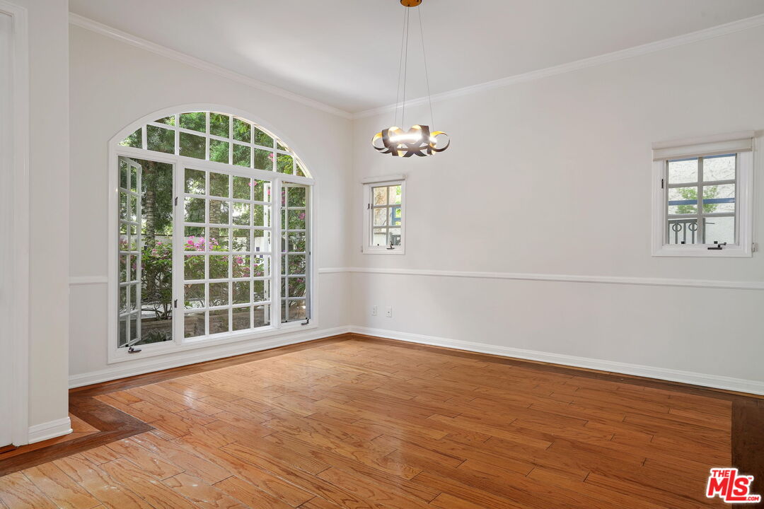 131 Reef Mall Marina del Rey, CA 90292 - Photo 9 of 43 an empty room with wooden floor and windows