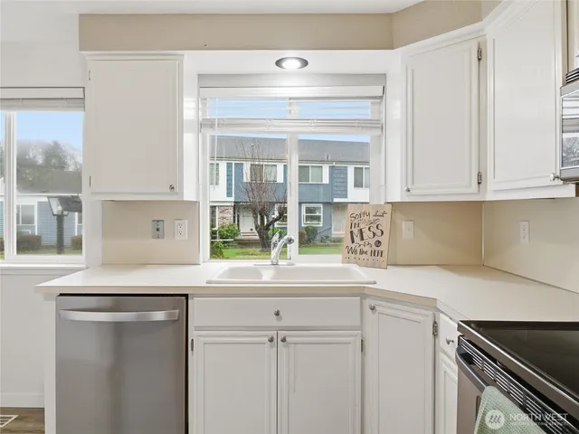 a kitchen with stainless steel appliances granite countertop a refrigerator and a stove