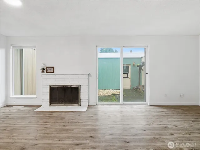 a view of a big room with wooden floor and staircase