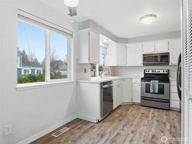 a kitchen with a sink appliances and cabinets