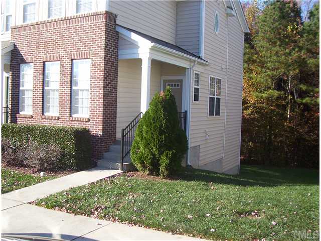 7880 Spungold Street Raleigh, NC 27617 - Photo 2 of 11 a front view of a house with garden