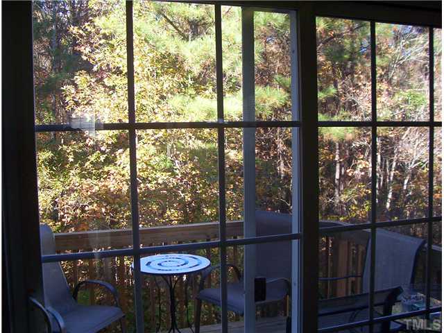 7880 Spungold Street Raleigh, NC 27617 - Photo 8 of 11 a view of a city from a dining room with large windows