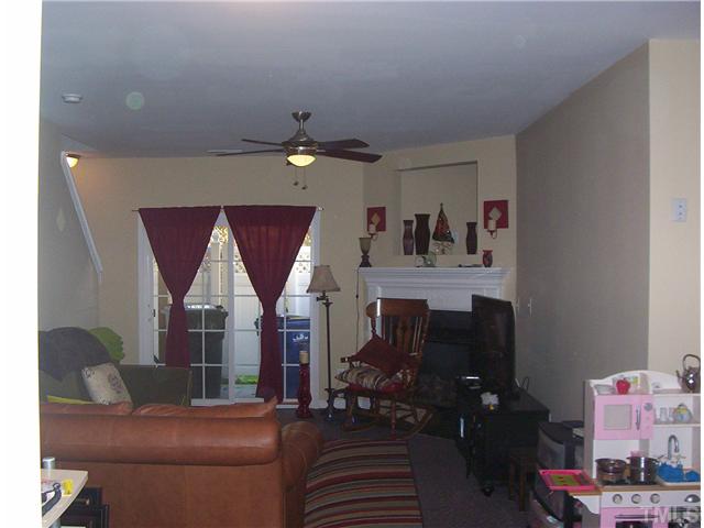 7880 Spungold Street Raleigh, NC 27617 - Photo 9 of 11 a living room with furniture and a window