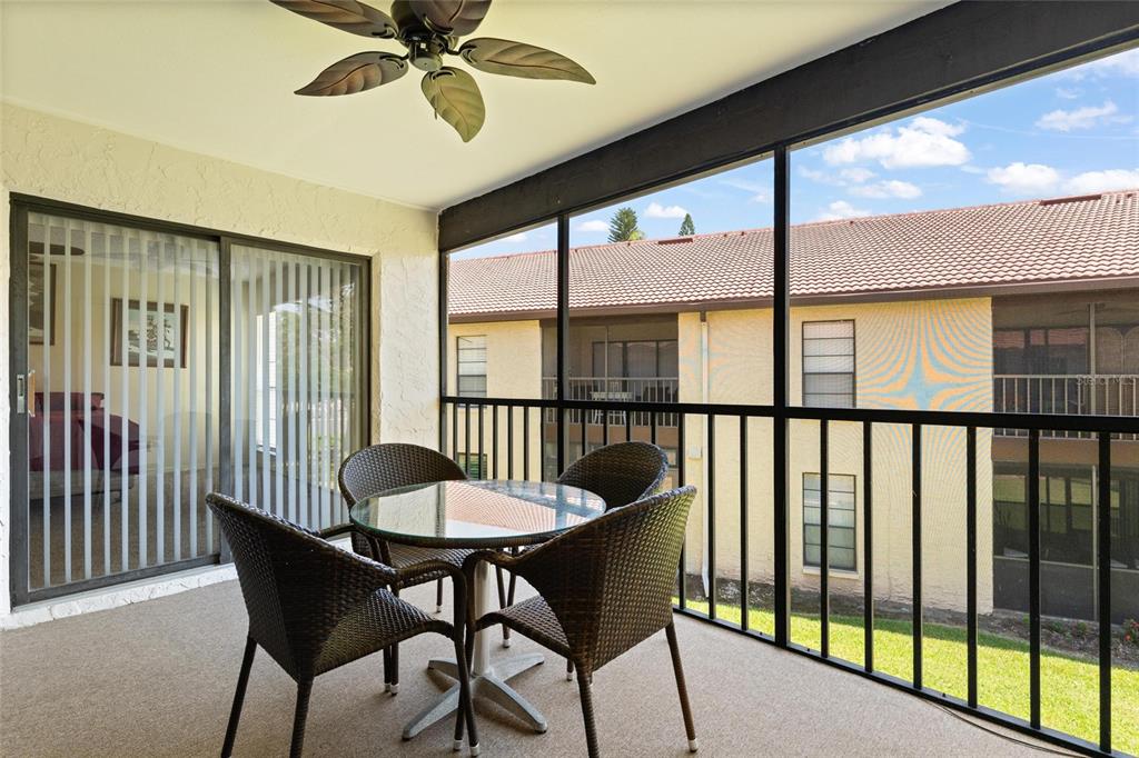 1801 East Lake Road South, Unit 4E Palm Harbor, FL 34685 - Photo 22 of 26 a view of a dining room with furniture window and outside view