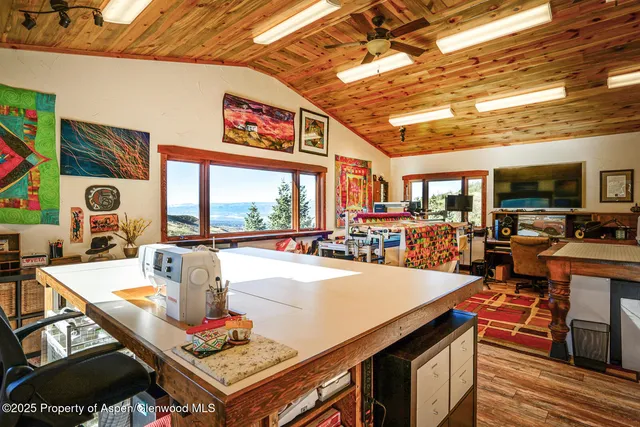 a view of a bedroom with wooden floor and windows