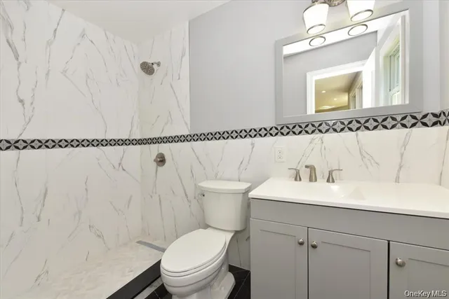 a bathroom with a sink a toilet and a mirror