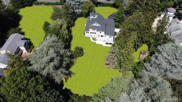 an aerial view of a house with a yard swimming pool outdoor seating and yard