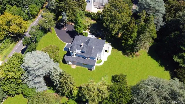 an aerial view of a house with a yard