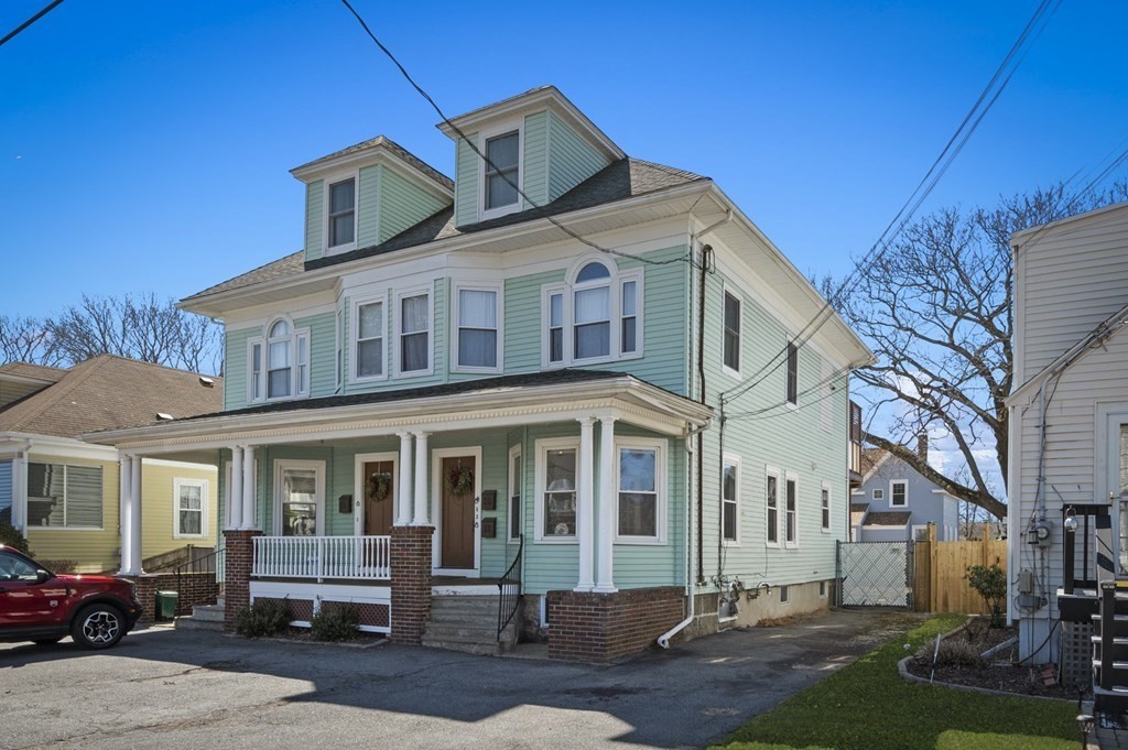 6 8 1/2 Devon Avenue, Unit 2 Beverly, MA 01915 - Photo 16 of 20 a front view of a house with a yard