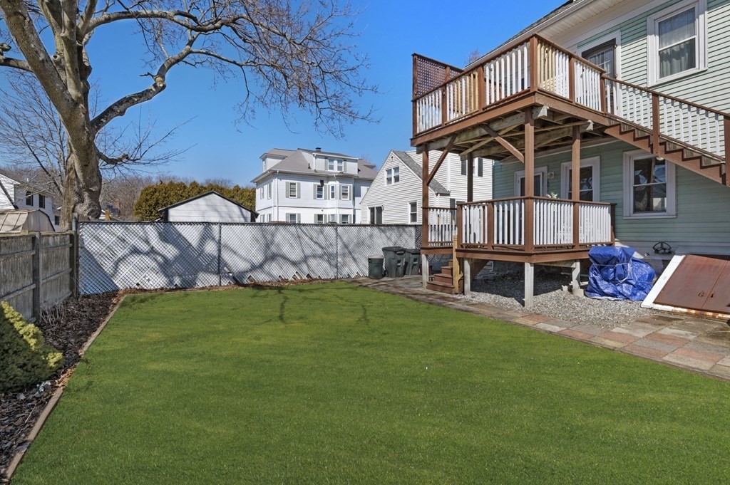 6 8 1/2 Devon Avenue, Unit 2 Beverly, MA 01915 - Photo 19 of 20 a view of a house with a yard deck and furniture