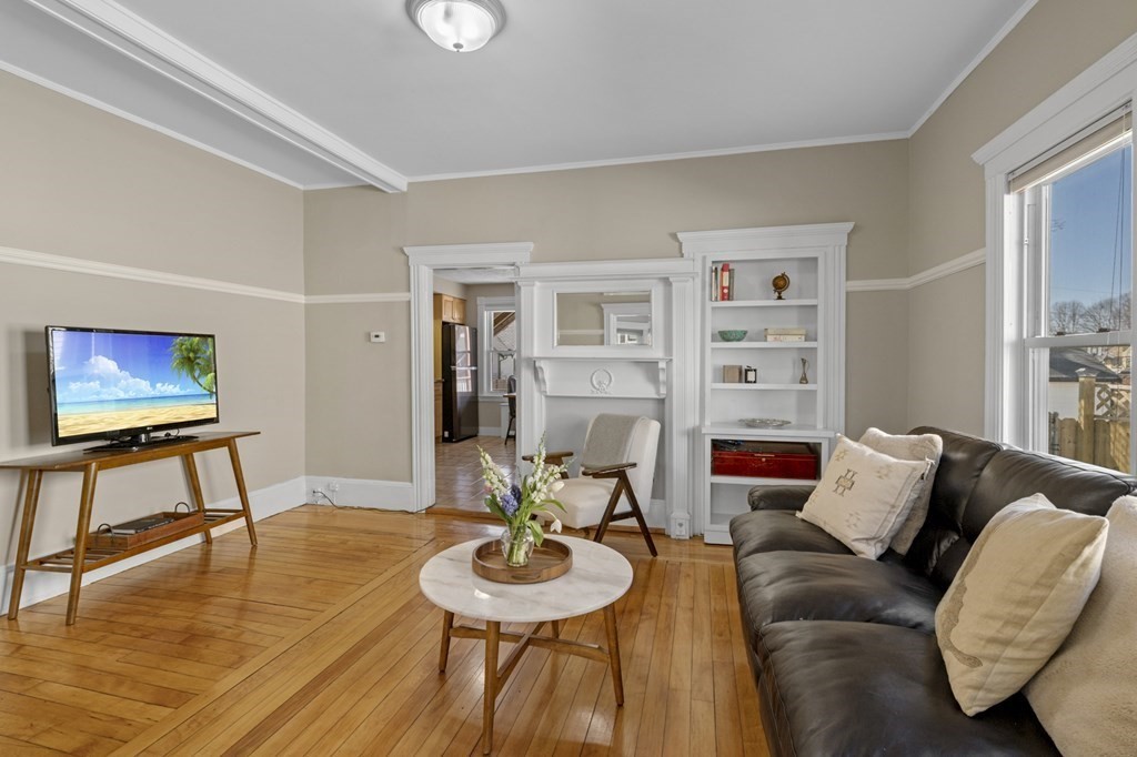 6 8 1/2 Devon Avenue, Unit 2 Beverly, MA 01915 - Photo 4 of 20 a living room with furniture and a wooden floor