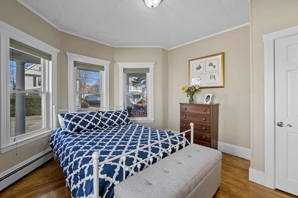 6 8 1/2 Devon Avenue, Unit 2 Beverly, MA 01915 - Photo 6 of 20 a bedroom with a bed and wooden floor