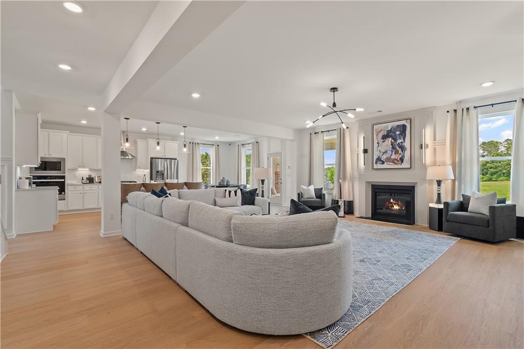 101 Buffalo Trace Stockbridge, GA 30281 - Photo 16 of 60 a living room with furniture a fireplace and a large window