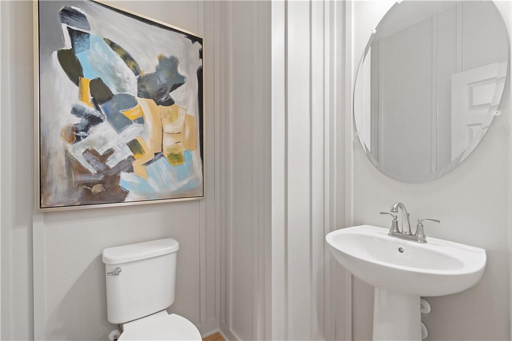 101 Buffalo Trace Stockbridge, GA 30281 - Photo 30 of 60 a bathroom with a toilet sink and mirror