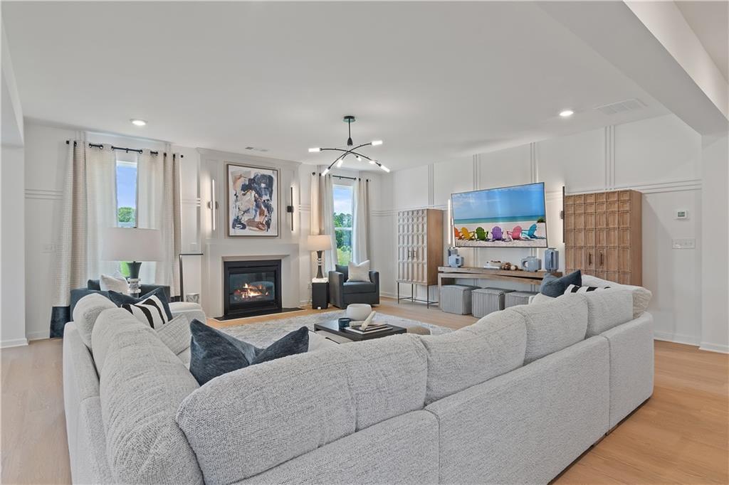 101 Buffalo Trace Stockbridge, GA 30281 - Photo 10 of 60 a living room with furniture a fireplace and a chandelier