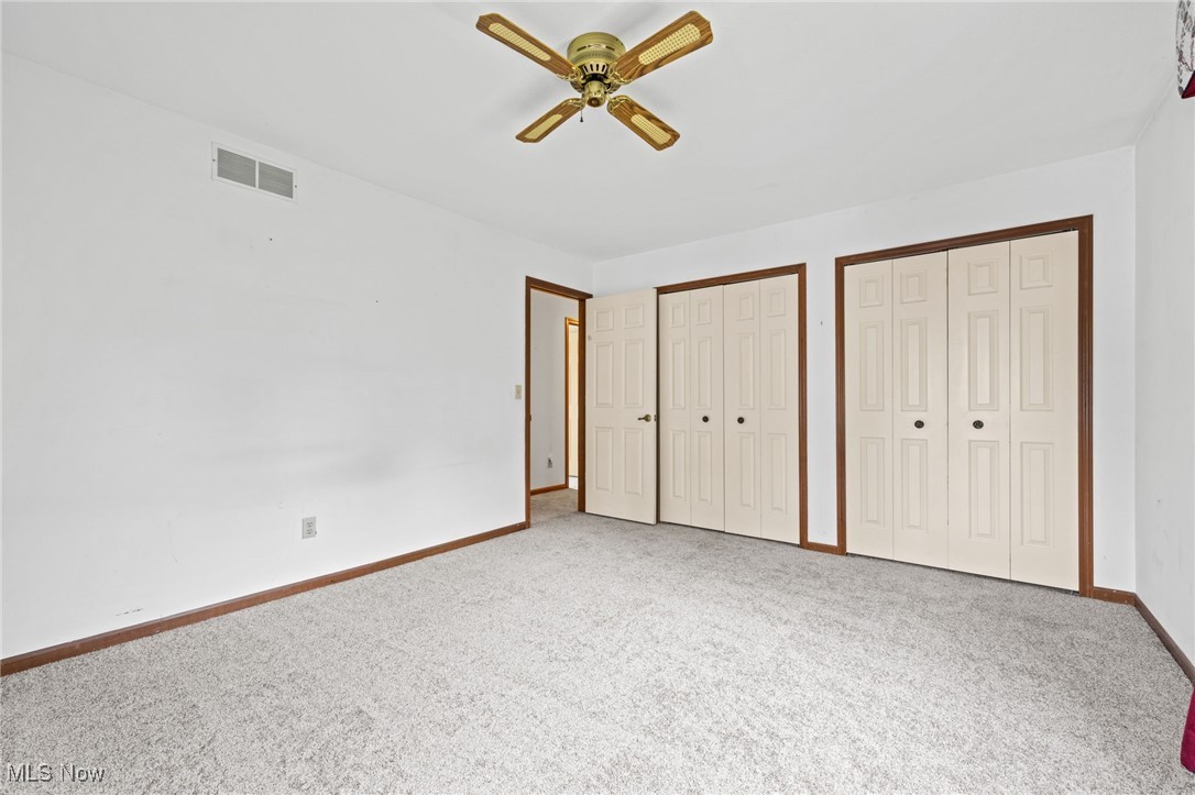 31655 Arthur Road Solon, OH 44139 - Photo 20 of 27 Bedroom featuring two closets, carpet, and ceiling fan
