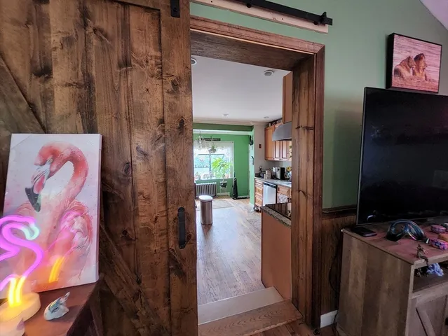 a view of a livingroom with furniture and a flat screen tv