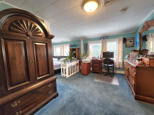 a bed sitting in a bedroom next to a window