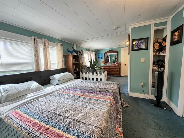 a living room with furniture and a gym machine